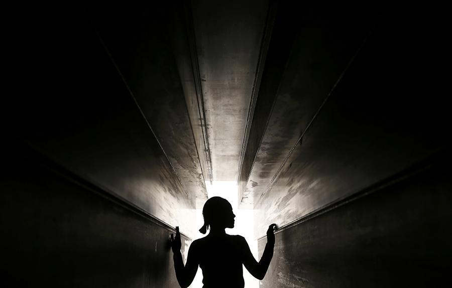 A member of the gallery poses for a photograph inside a piece called "Passage", by artist Antony Gormley, which forms part of an exhibition entitled "Fit", at the White Cube gallery in London, Britain September 29, 2016.   REUTERS/Peter Nicholls